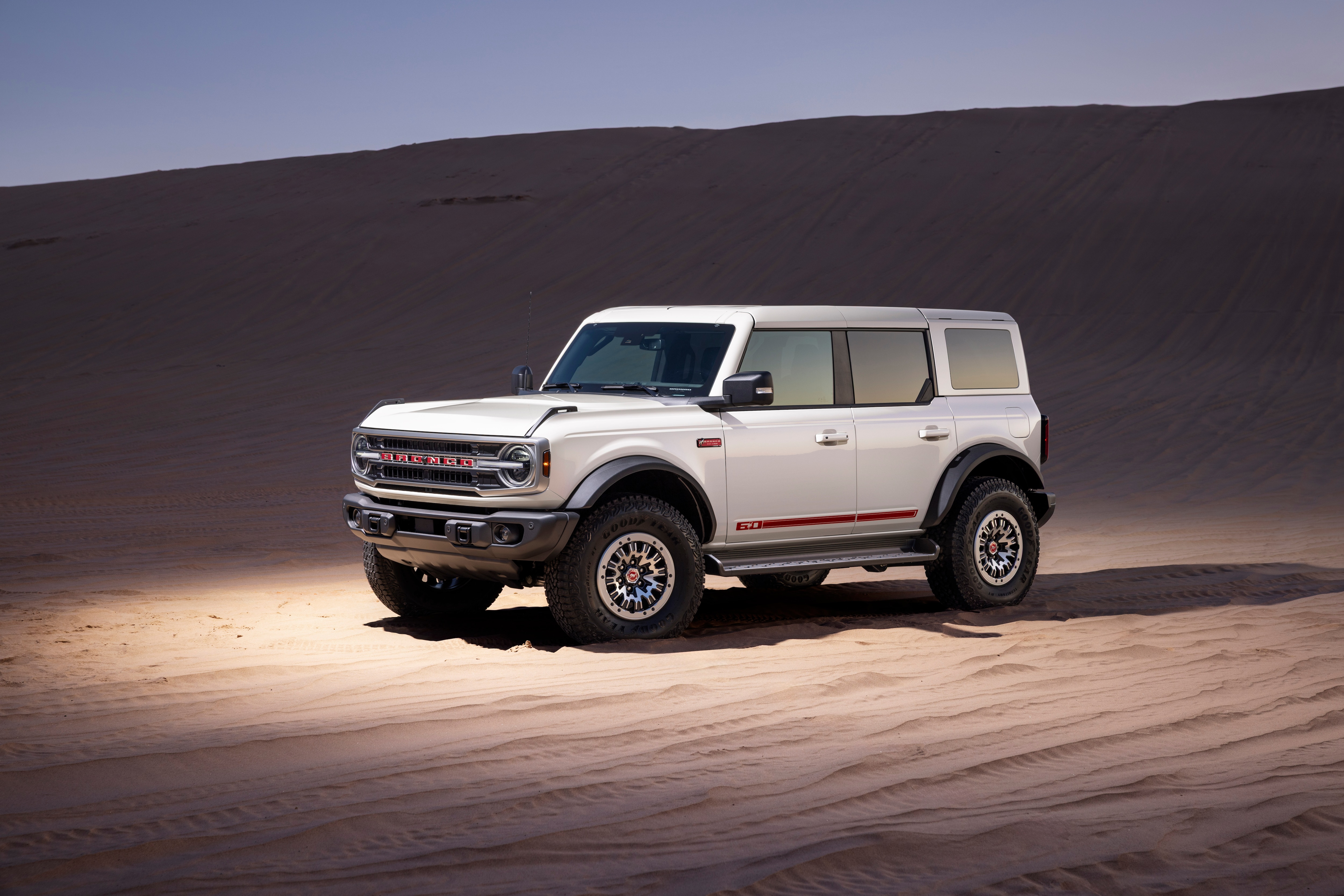 Preproduction model shown. The Bronco 60th Anniversary Package blends bolder colors and accents in the cabin, timeless visuals on the exterior, and the same uncompromising off-road capability owners expect. 